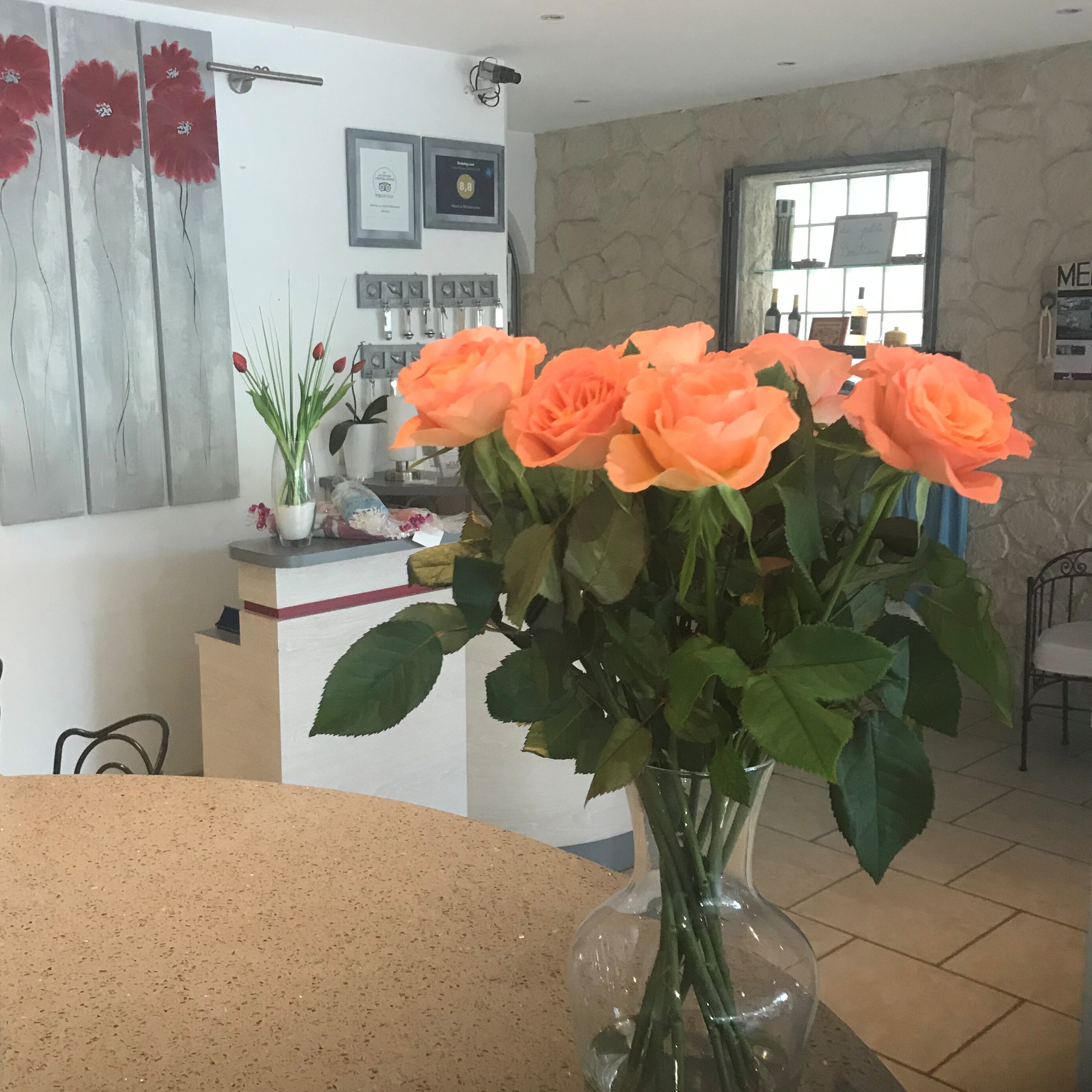 A bouquet of orange flower on a counter in the reception
